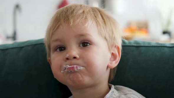 Baby Child Is Feed With Spoon With Yogurt Porridge Whole Mouth Is Smeared