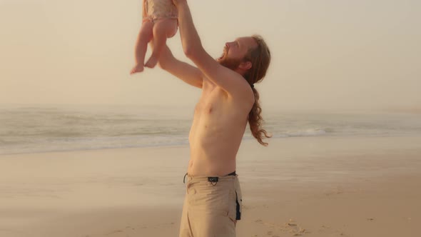 Happy Family in Seaside Caucasian Bearded Father Playing with Son Daughter Infant Child Near Sea