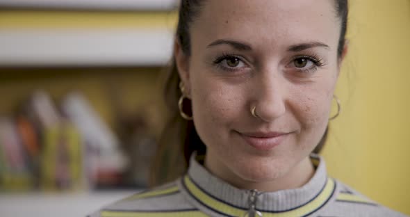 Portrait of young woman at home smiling and looking at camera