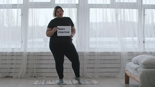 Concept Body Positivity  a Chubby Smiling Woman Holds a Sign with the Inscription BODY POSITIVE
