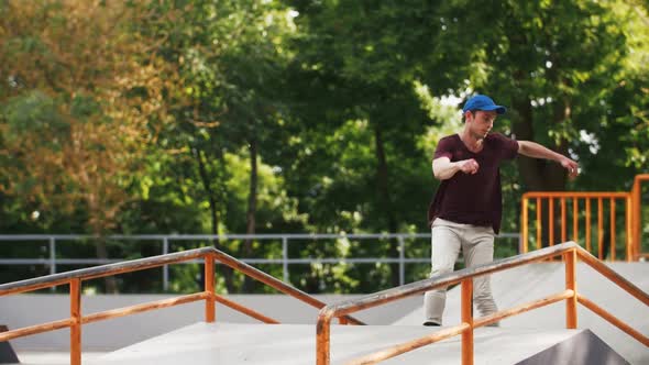 Aggressive Inline Roller Skater Doing Tricks in Concrete Skatepark Outdoors with Beautiful