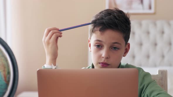 Little Boy During COVID19 Quarantine Attending To Online School Class From His Room