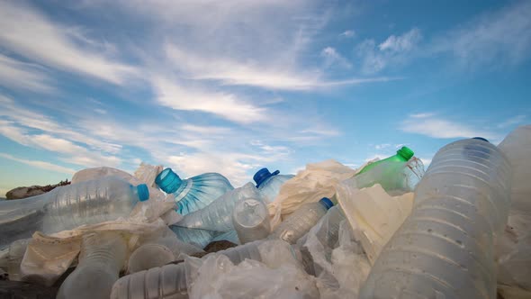 Timelapse. Plastic Bottles in a Polluted. Clouds Background