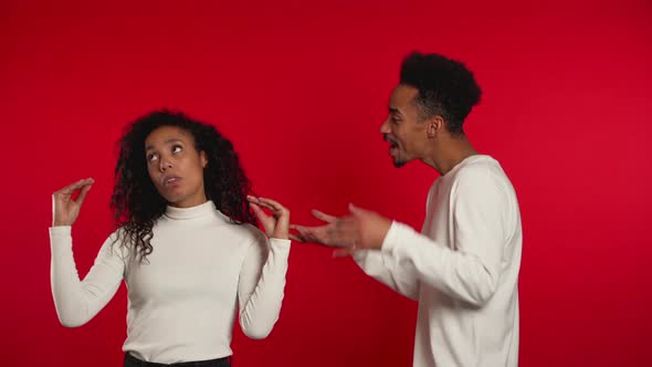 African Woman Showing Bla-bla Gesture While Boyfriend Trying To Say Something