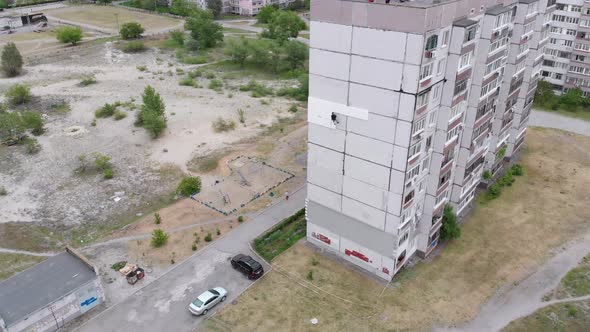 Industrial Alpinism. Aerial View. Work on Outer Insulate Building with Styrofoam