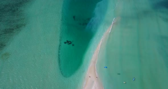 Tropical aerial travel shot of a summer white paradise sand beach and blue water background in color