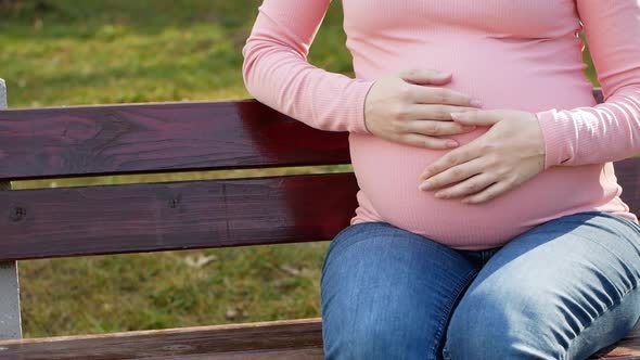 Pregnant woman feeling happy at home while taking care of her child. Maternity prenatal care