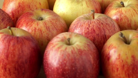 Close Up of Fresh Red-yellow Apples Rotate on Board. Harvest Time. Healthy and Organic Food Concept.