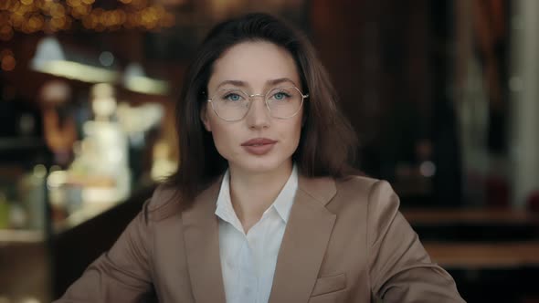 Portrait of Confident Business Woman Sitting at Cafe