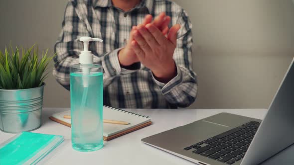 Man Clean Hands with Alchohol Gel to Protect Against Coronavirus or COVID19