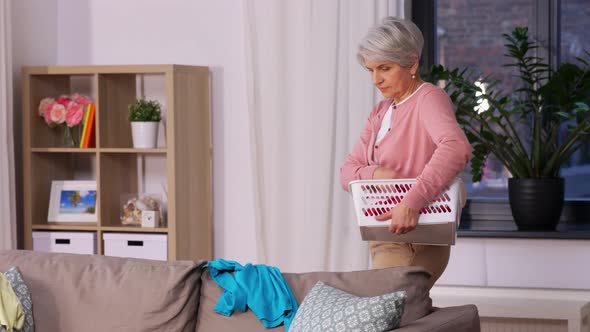 Senior Woman Picking Clothes for Laundry at Home