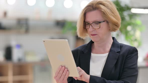 Portrait of Middle Aged Businesswoman Having Loss on Tablet