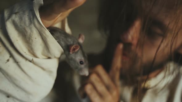 Crazy Terrible Maniac In Basement With Window Playing With Rat