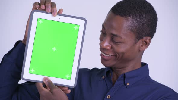 Face of Young Happy African Businessman Showing Digital Tablet