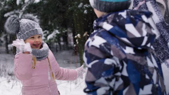 Video of family gives themselves high fives for winter fun. Shot with RED helium camera in 8K.