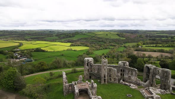 Aerial forward over Llawhaden Castle ruins in Pembrokeshire, Wales. UK