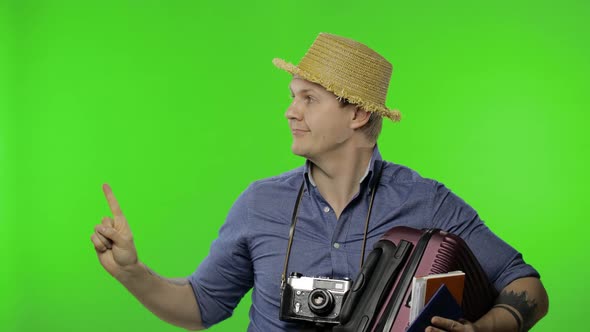 Portrait of Young Man Tourist Photographer Pointing at Something. Chroma Key