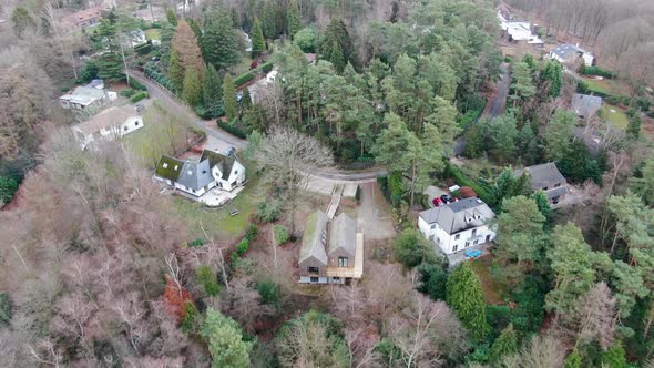 Aerial View of Big Villas with Garden Surrounded By Forest During Winter Season