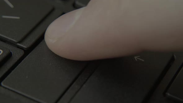 The Finger Presses the Enter Button on the Keyboard