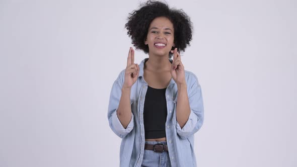 Young Beautiful African Woman Wishing with Fingers Crossed