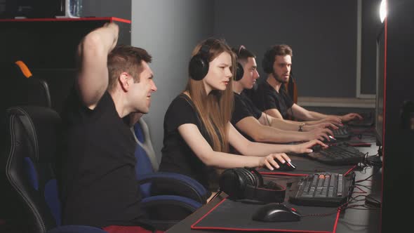 Team of Gamers Emotionally Rejoices in Victory Playing in E-sport Club