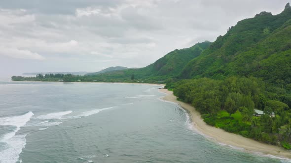 Aerial View Flying Over Tropical Coral Reef Lagoon Towards Green Mountains Kauai