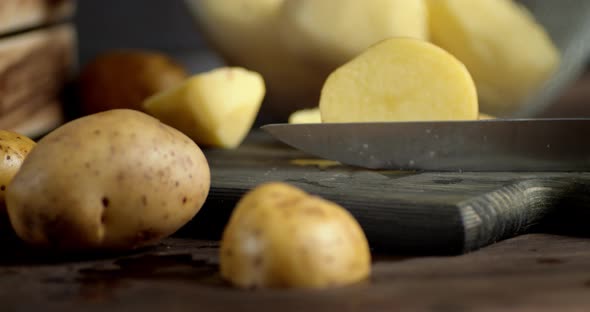 With a Knife Cut Fresh Potatoes Into Two Halves