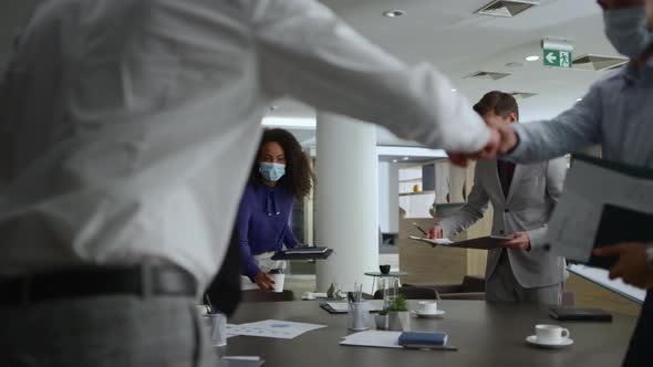 Diverse Corporate Team Meeting Wearing Face Mask in Office Table