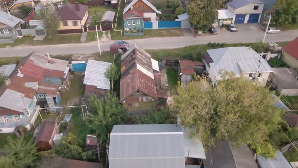 Aerial View of a City Street with Small Houses and a Road with a Car