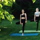 Two Young Women is Practicing Yoga in Park While Sunrise in Slow Motion - VideoHive Item for Sale