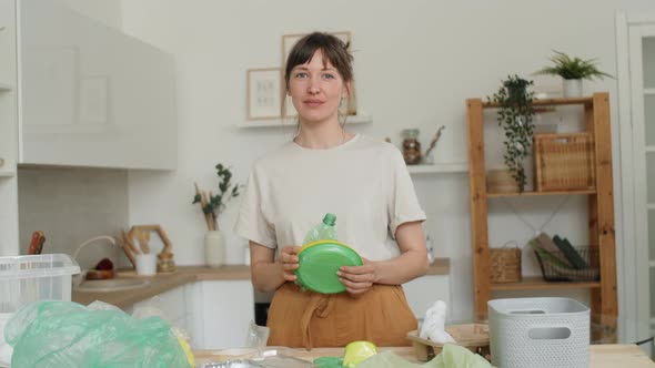Portrait of Beautiful Woman Sorting Plastics at Home