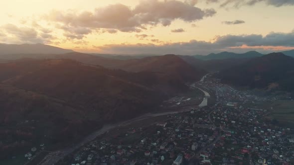 Wonderful Town at Hill Foot and River Against Rising Sun