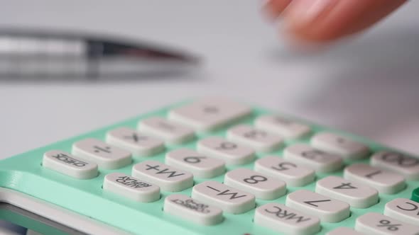 Close Up of Man Hand Using Calculator 