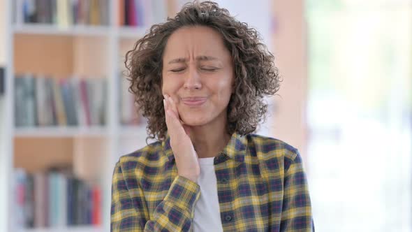 Portrait of Young Mixed Race Woman with Toothache