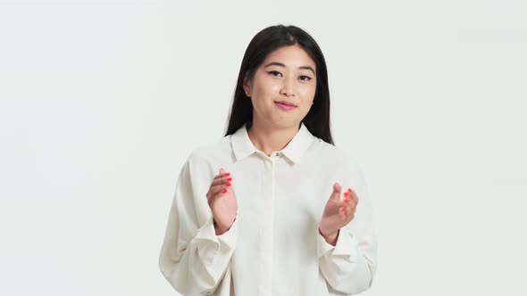 Frustrated asian korean woman clapping her hands