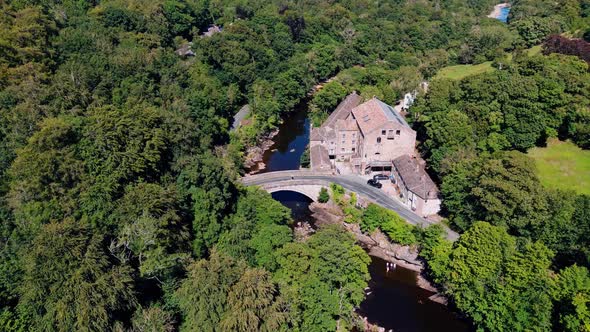 Ariel drone view of Aysgarth Falls and bridge on a summers dayThe three stepped waterfalls at Aysga