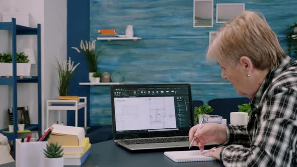 Middle Aged Woman Engineer Working with Architectural Plans