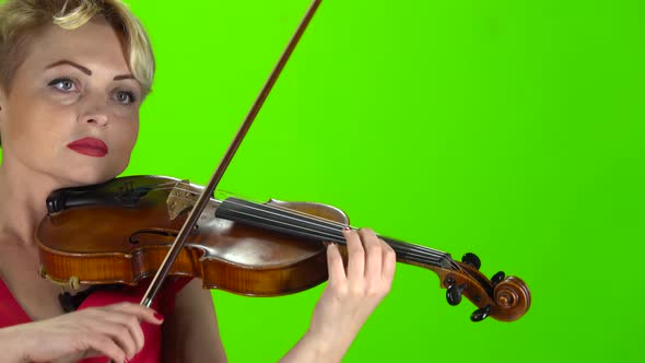 Woman Plays the Violin. Green Screen. Close Up