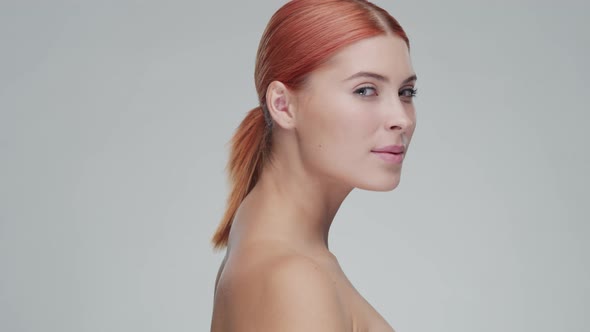 Studio portrait of young, beautiful and natural redhead woman. Beauty concept.