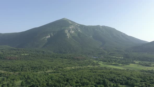 Slow flying over the valley under montain Rtanj in Serbia 4K aerial video