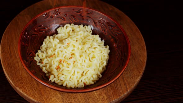 Readymade Instant Noodles in Plate on Wooden Board