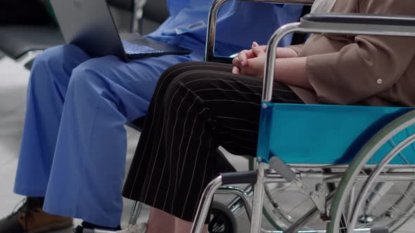 Medical Assistant Showing Bones Radiography to Woman with Chronic Disability