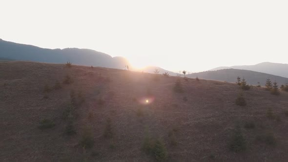 Newlyweds Dancing on a High Slope of the Mountain. Groom and Bride. Aerial View