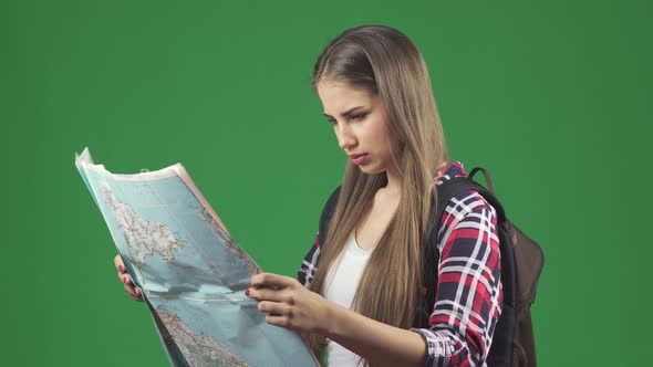 Beautiful Young Female Tourist Looking at the Map with a Confused Expression