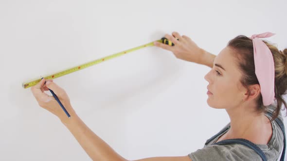 Portrait of a Caucasian woman in quarantine during coronavirus pandemic, doing interior work