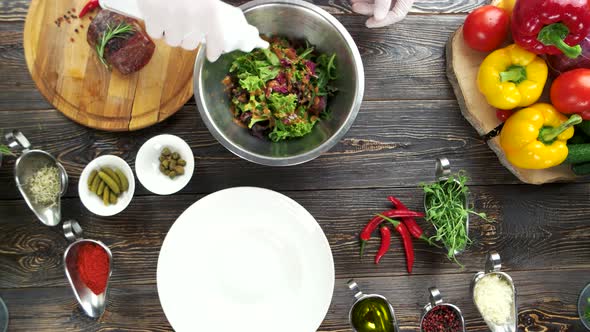 Hand Adding Mustard To Salad.