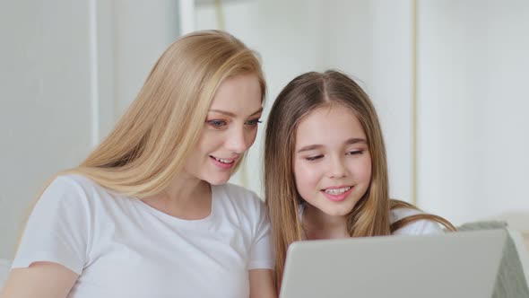 Middleaged Adult Woman Mother and Schoolgirl Teenager Child Daughter Sitting Together at Home