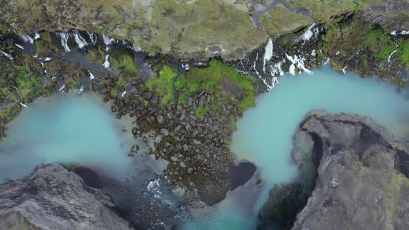 Turquoise river with waterfalls in highlands