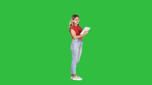 Woman in Casual Using Tablet on A Green Screen, Chroma Key