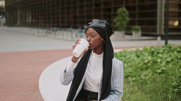 Muslim Woman Drinking Coffee on Street